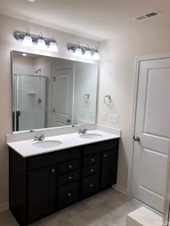 a bathroom with a double vanity sink mirror and