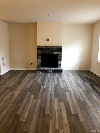 a view of an empty room and wooden floor