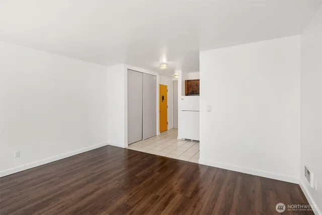 a view of an empty room with wooden floor