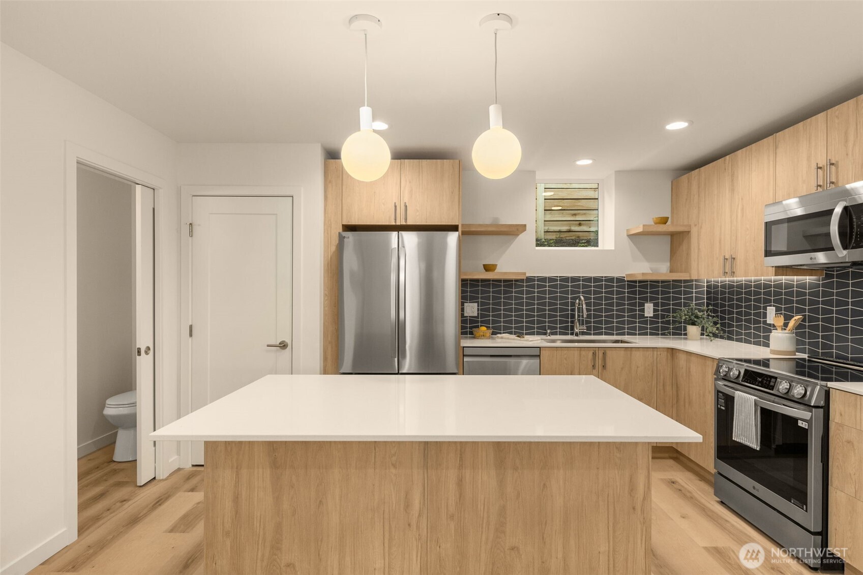 3916 South Juneau Street Seattle, WA 98118 - Photo 16 of 40 a view of a kitchen with a sink and dishwasher a refrigerator with wooden floor