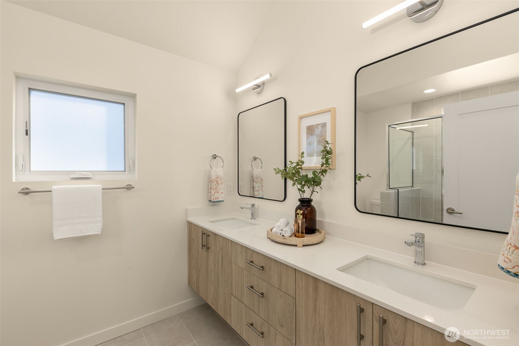 3916 South Juneau Street Seattle, WA 98118 - Photo 29 of 40 a bathroom with double vanity sinks and a mirror