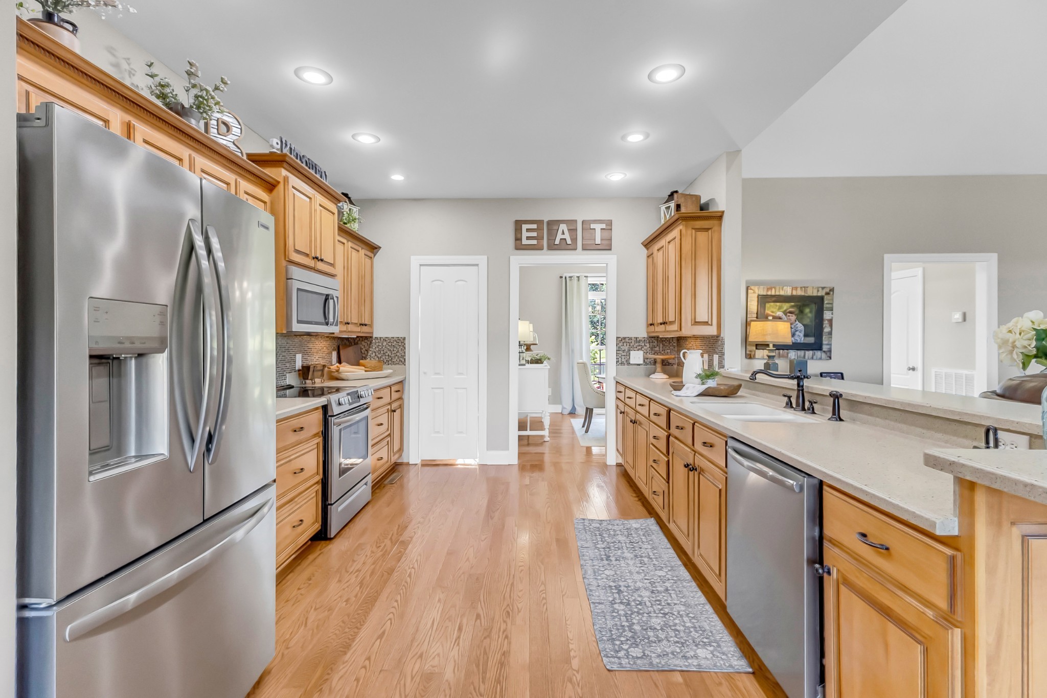 226 Ranch Road Portland, TN 37148 - Photo 14 of 54 a large kitchen with stainless steel appliances lots of counter space and wooden floor