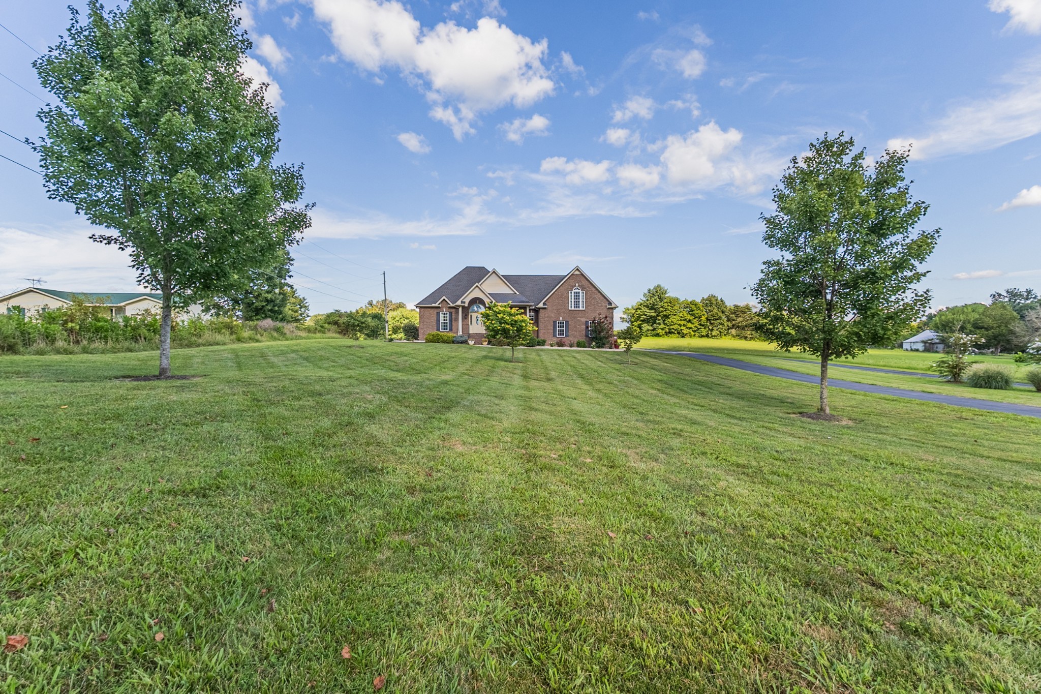 226 Ranch Road Portland, TN 37148 - Photo 7 of 54 a view of a field with plants and large trees