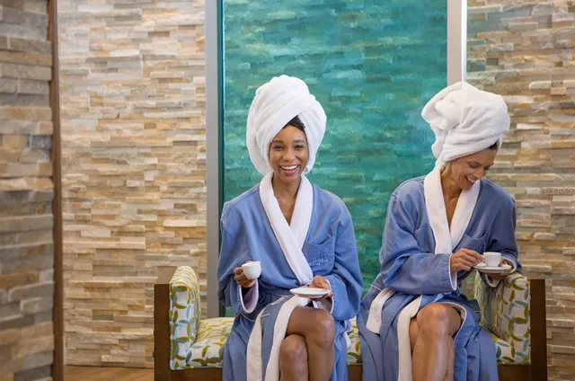 a dining room with furniture and a floor to ceiling window
