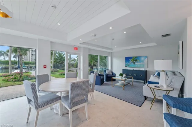 a swimming pool with outdoor seating and yard