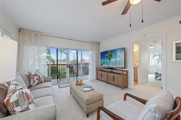a living room with furniture a rug and white walls