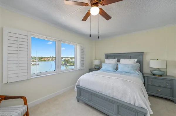 a bedroom with furniture and a large window