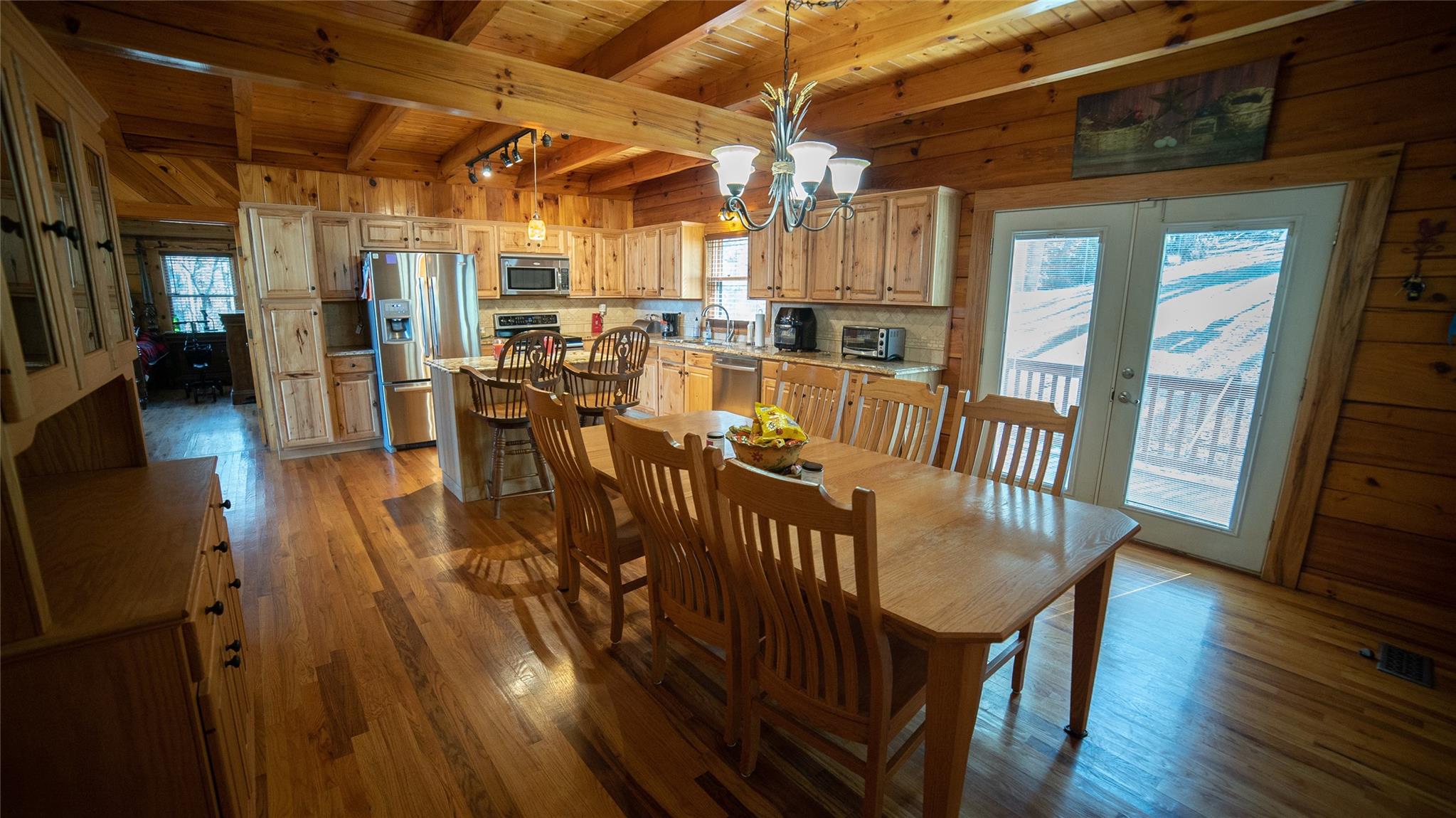 2525 Winkler Way Road Lenoir, NC 28645 - Photo 20 of 47 a view of a dining room with furniture wooden floor and a chandelier