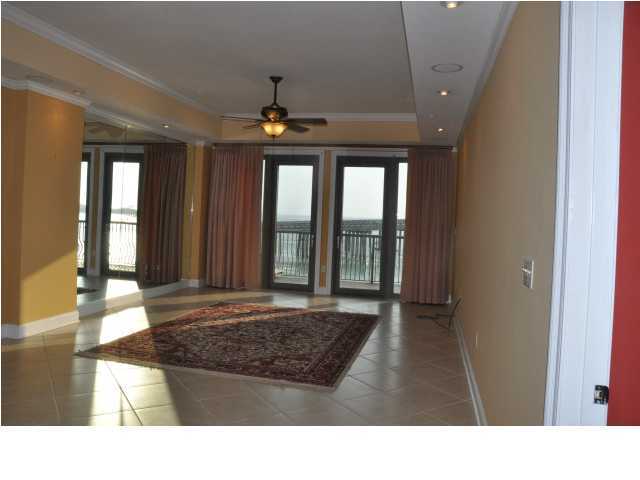 5 Calhoun Avenue, Unit 407 Destin, FL 32541 - Photo 15 of 27 a living room with a bed and a large window