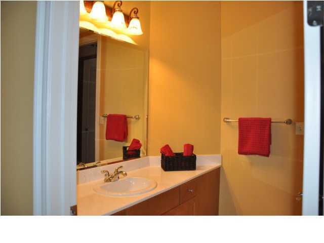 5 Calhoun Avenue, Unit 407 Destin, FL 32541 - Photo 17 of 27 a bathroom with a sink and a mirror