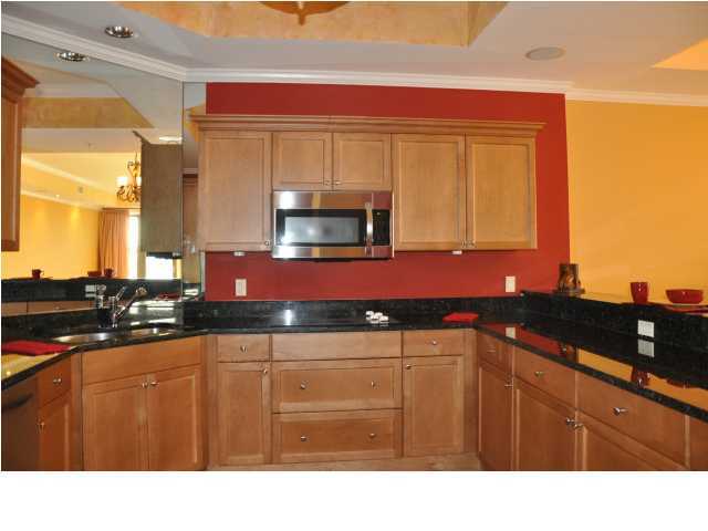 5 Calhoun Avenue, Unit 407 Destin, FL 32541 - Photo 4 of 27 a kitchen with granite countertop a sink stainless steel appliances and cabinets