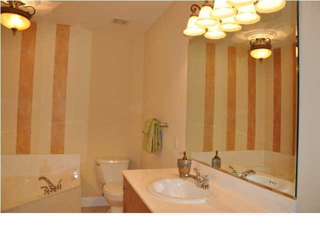 5 Calhoun Avenue, Unit 407 Destin, FL 32541 - Photo 6 of 27 a bathroom with a sink vanity granite and a mirror