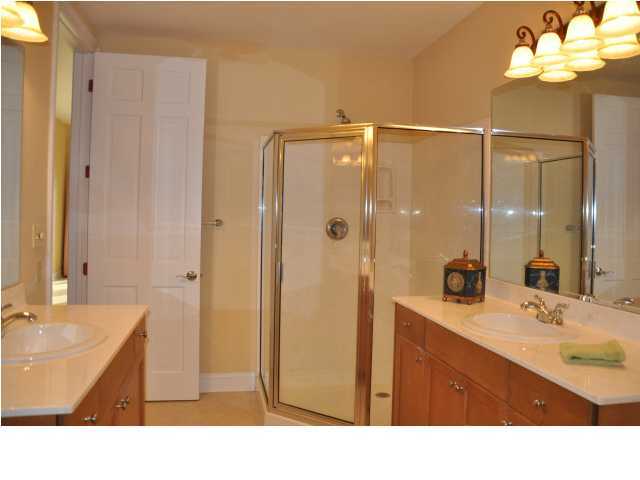 5 Calhoun Avenue, Unit 407 Destin, FL 32541 - Photo 7 of 27 a bathroom with a sink a double vanity and a mirror