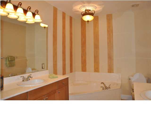 5 Calhoun Avenue, Unit 407 Destin, FL 32541 - Photo 8 of 27 a bathroom with a sink vanity tub and a mirror