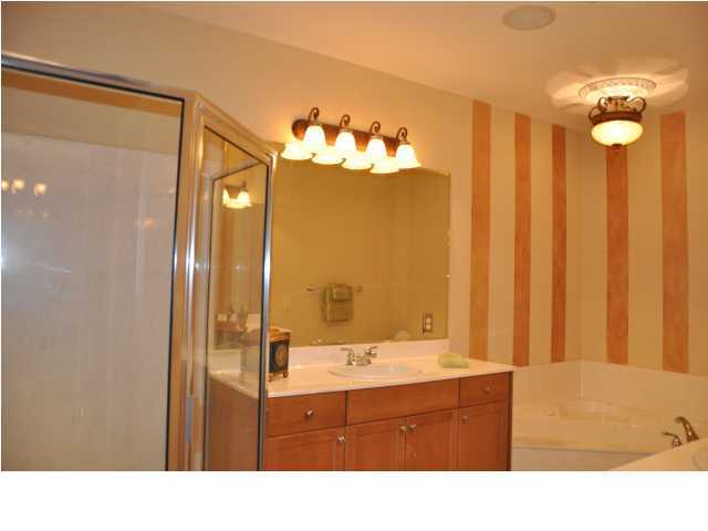 5 Calhoun Avenue, Unit 407 Destin, FL 32541 - Photo 9 of 27 a bathroom with a sink double vanity and a mirror