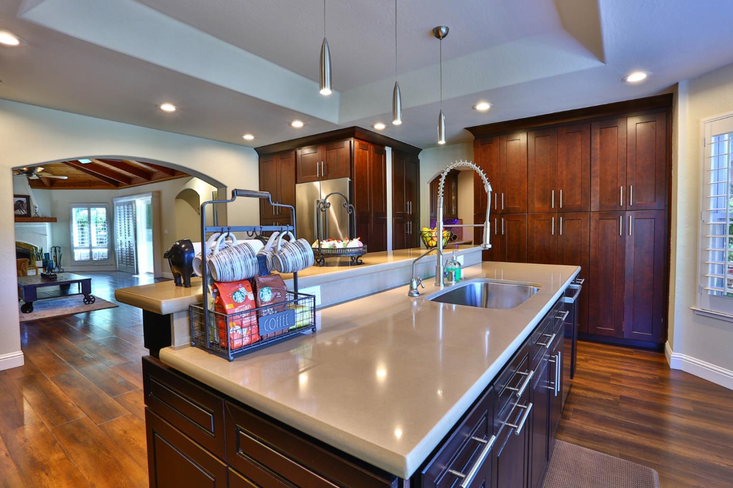 2000 Day Road Gilroy, CA 95020 - Photo 9 of 51 a large kitchen with stainless steel appliances granite countertop a stove a oven a dining table and chairs with wooden floor