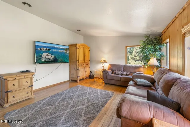 a living room with fireplace furniture and a flat screen tv