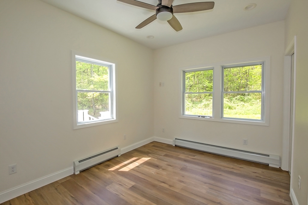 165 Sandisfield Road Sandisfield, MA 01255 - Photo 17 of 37 a view of a room with wooden floor and windows