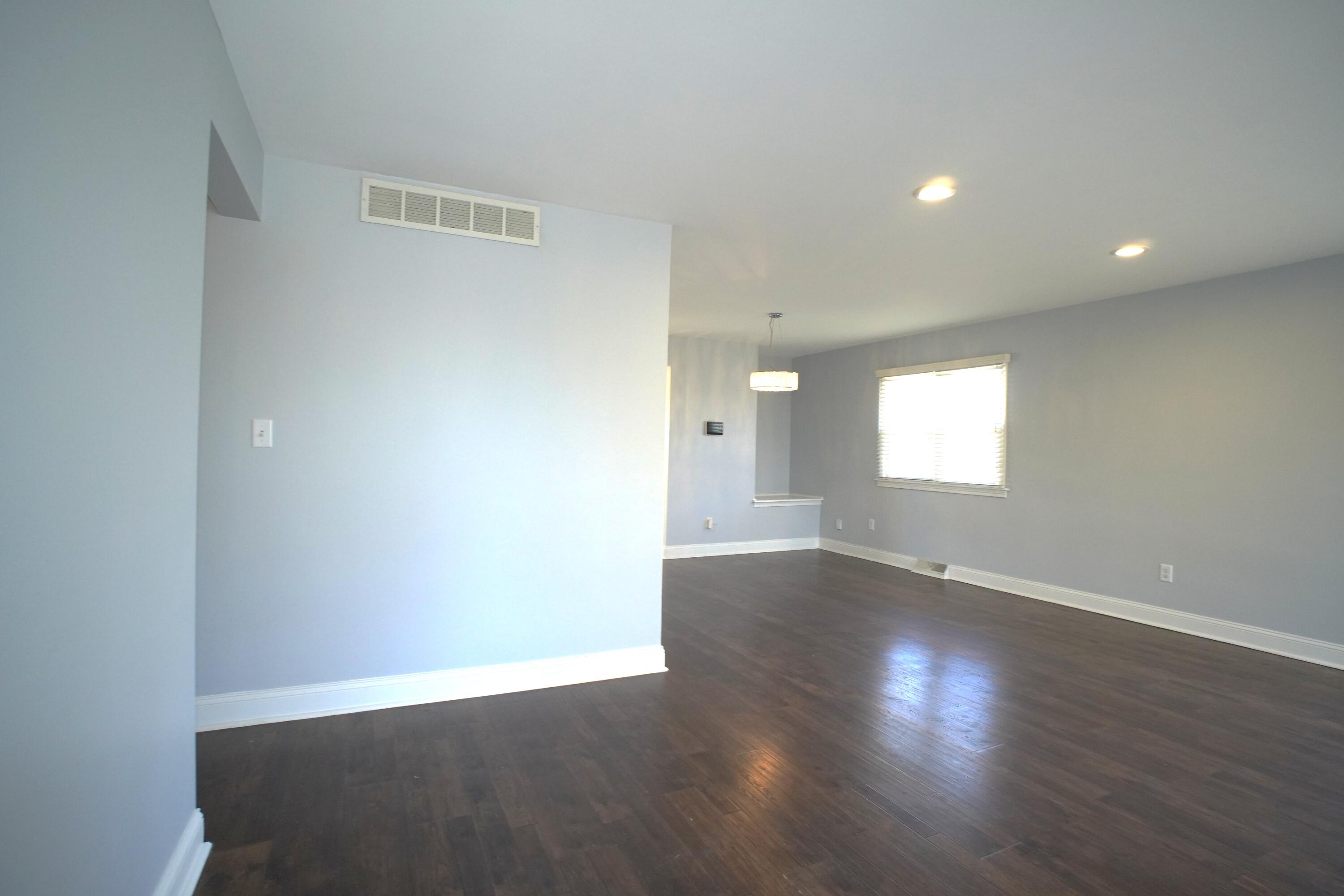 1312 Bigger Street Gary, IN 46404 - Photo 14 of 33 an empty room with wooden floor and windows