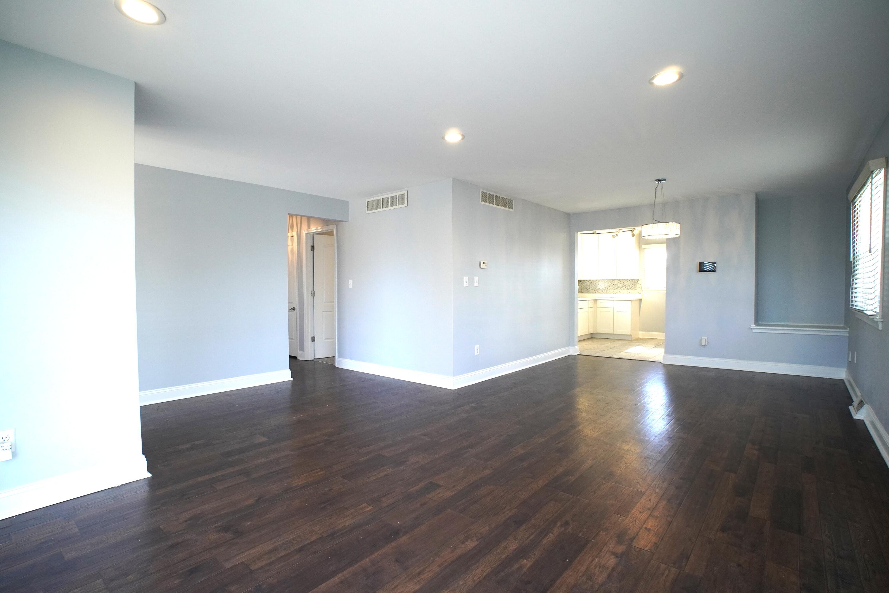 1312 Bigger Street Gary, IN 46404 - Photo 15 of 33 a view of an empty room with wooden floor and a window