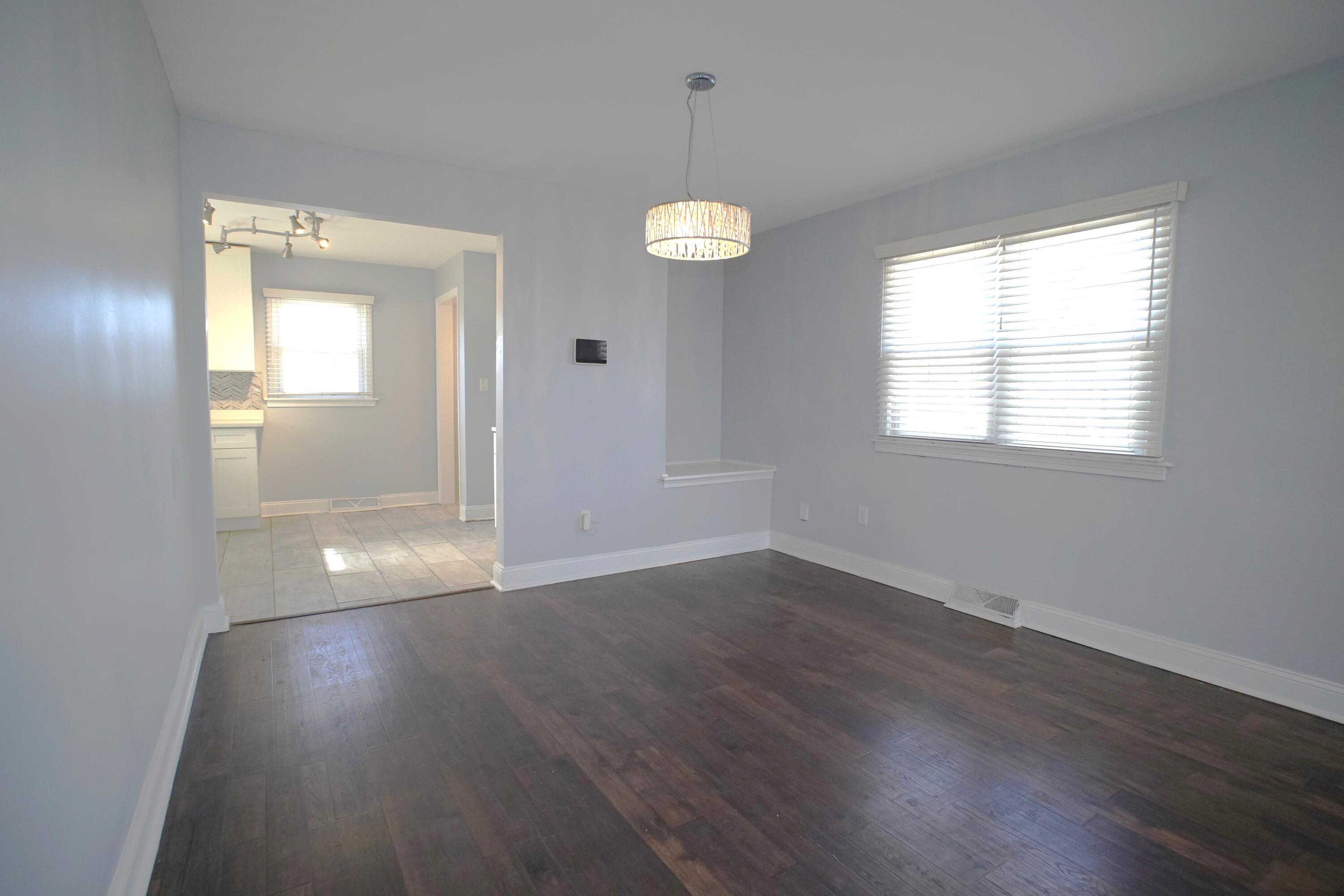 1312 Bigger Street Gary, IN 46404 - Photo 16 of 33 an empty room with wooden floor and windows