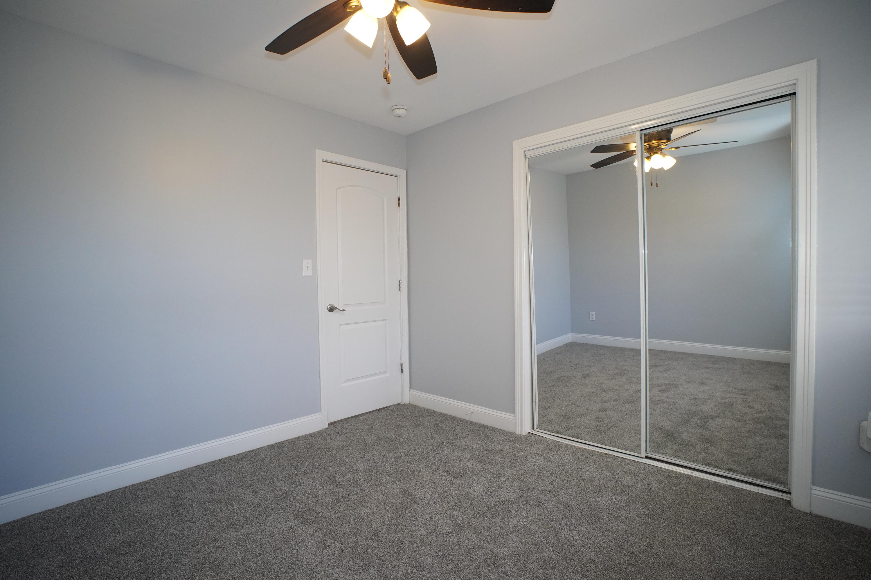 1312 Bigger Street Gary, IN 46404 - Photo 20 of 33 an empty room with a ceiling fan and a shower