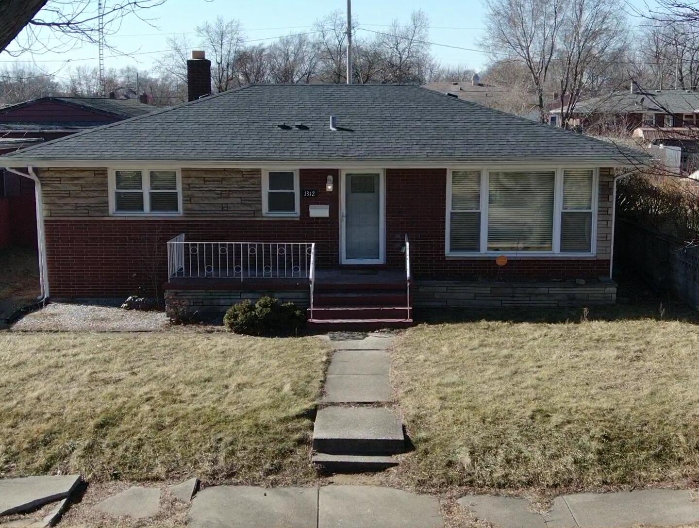 1312 Bigger Street Gary, IN 46404 - Photo 2 of 33 a front view of a house with a yard