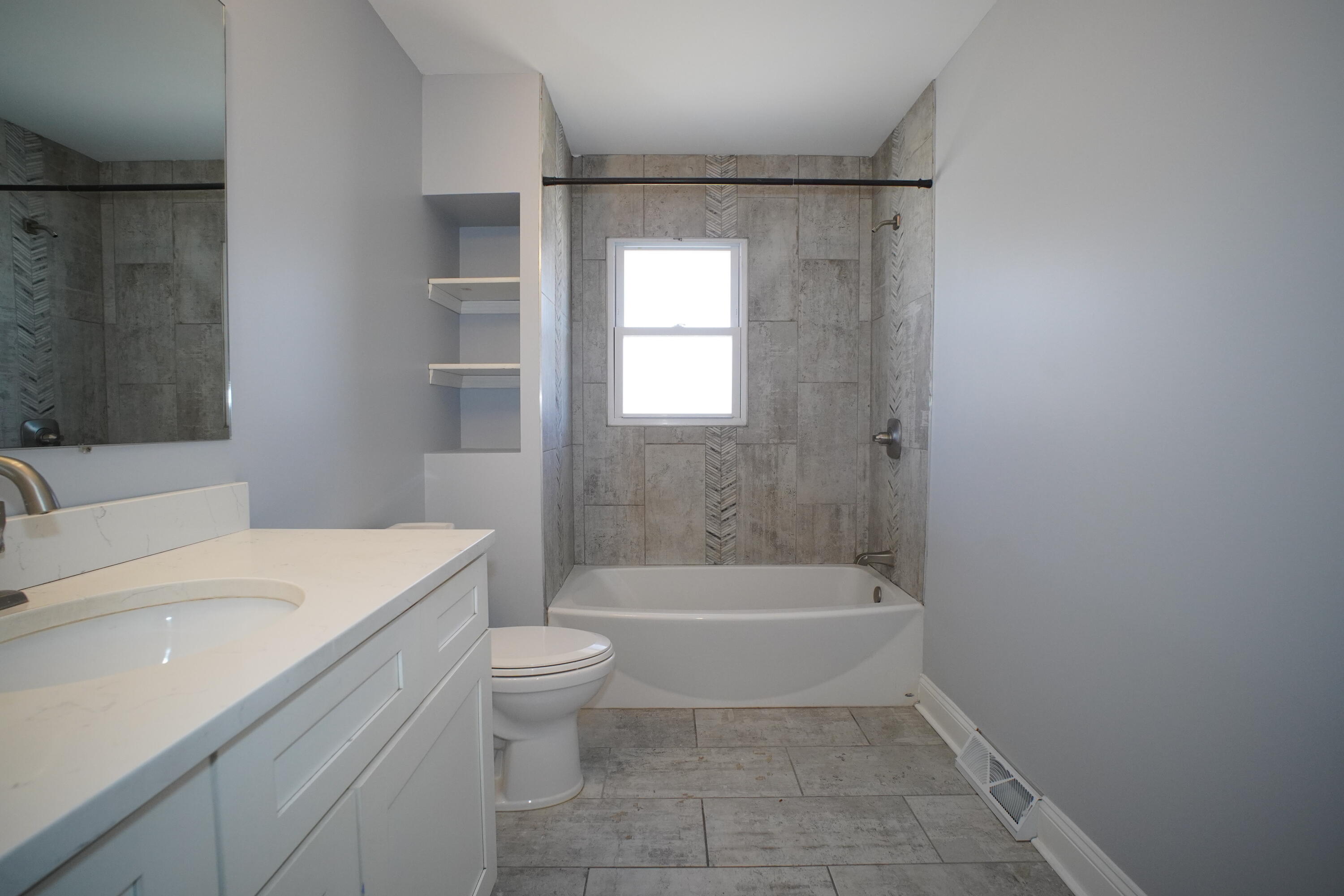 1312 Bigger Street Gary, IN 46404 - Photo 22 of 33 a bathroom with a sink a toilet and bathtub