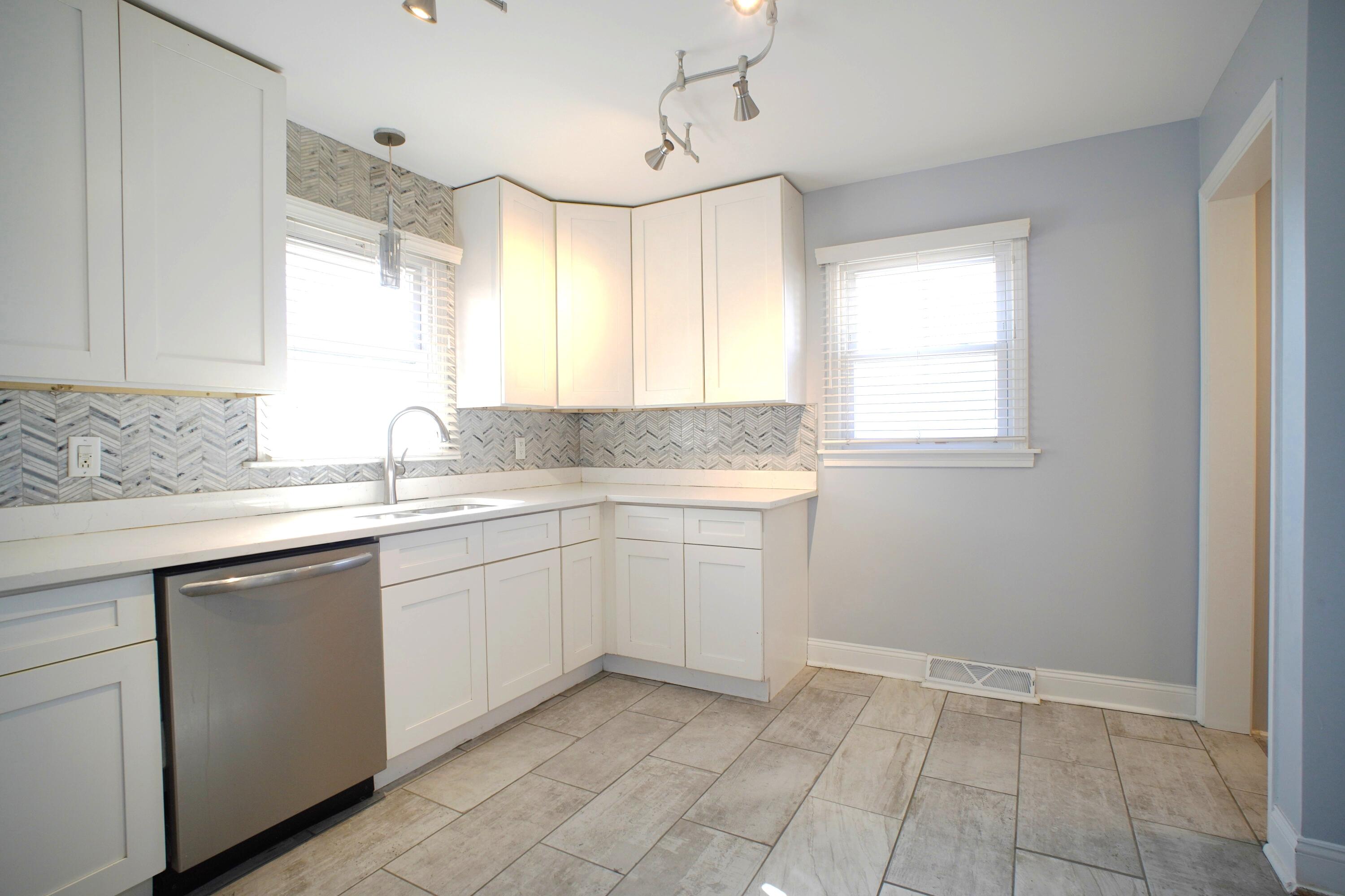 1312 Bigger Street Gary, IN 46404 - Photo 25 of 33 a kitchen with sink cabinets and window