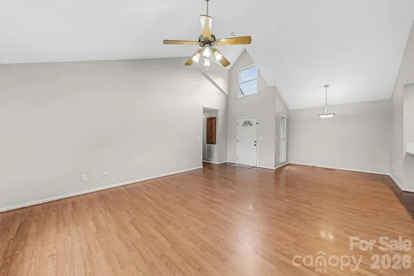 a kitchen with stainless steel appliances a sink cabinets and wooden floor