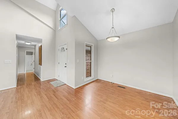 a kitchen with stainless steel appliances a sink cabinets and wooden floor