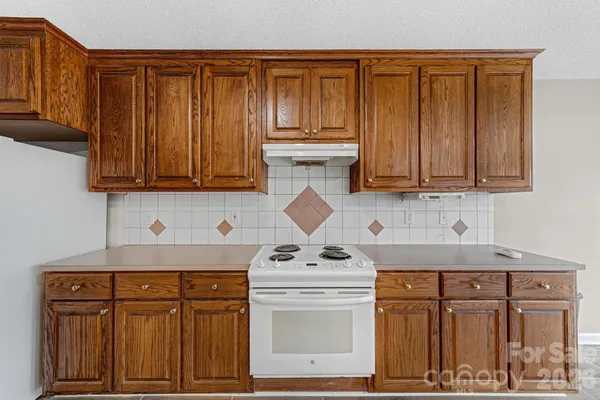 an empty room with a window and a ceiling fan