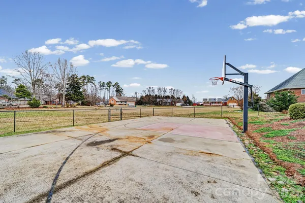 a view of a playground with basketball court