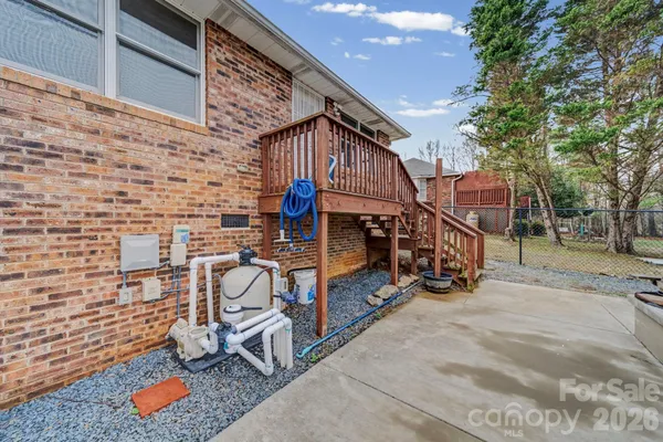 a large kitchen with stainless steel appliances granite countertop a stove a sink dishwasher and a oven with white cabinets