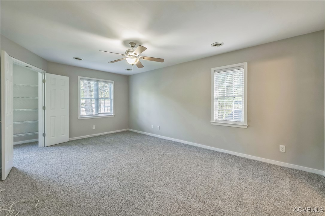 12004 Taplow Road Midlothian, VA 23112 - Photo 18 of 32 an empty room with windows and ceiling fan