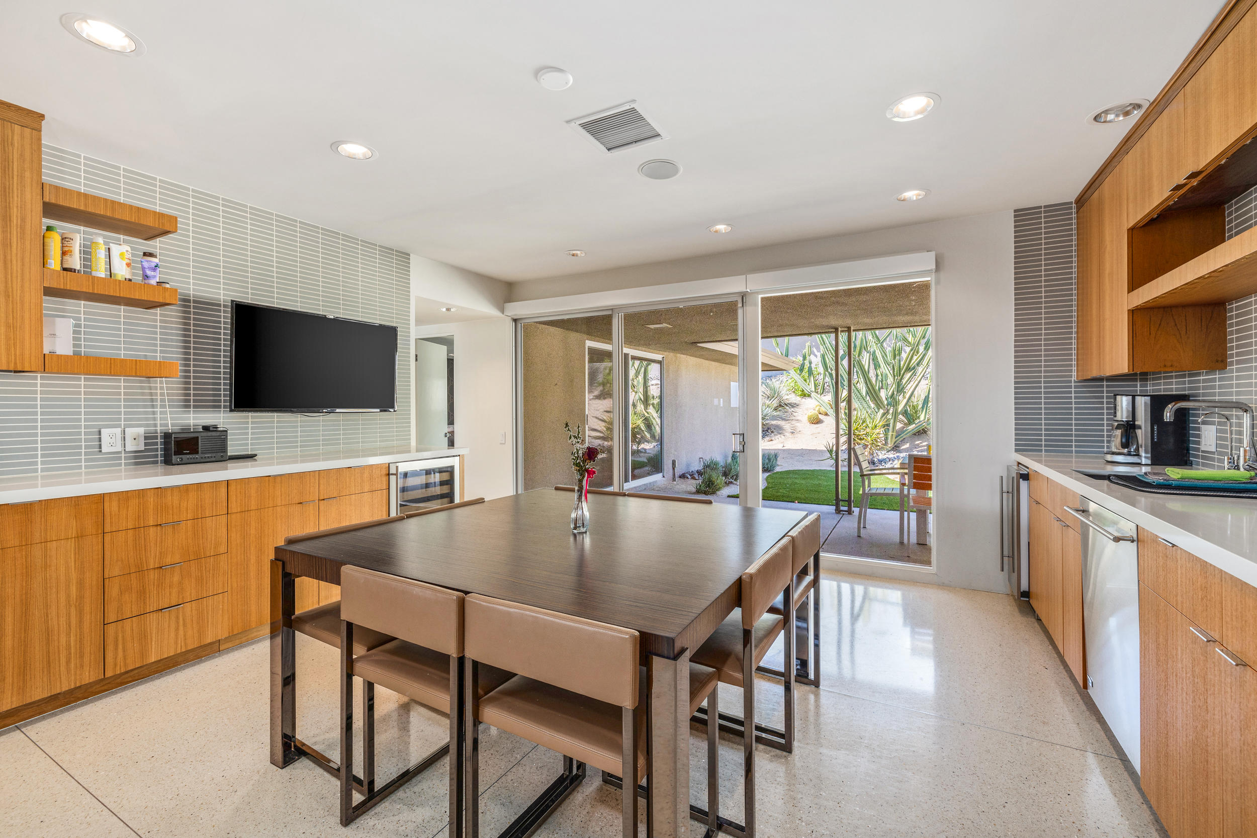 70411 Pecos Road Rancho Mirage, CA 92270 - Photo 13 of 44 a kitchen with stainless steel appliances granite countertop table chairs sink and stove top oven