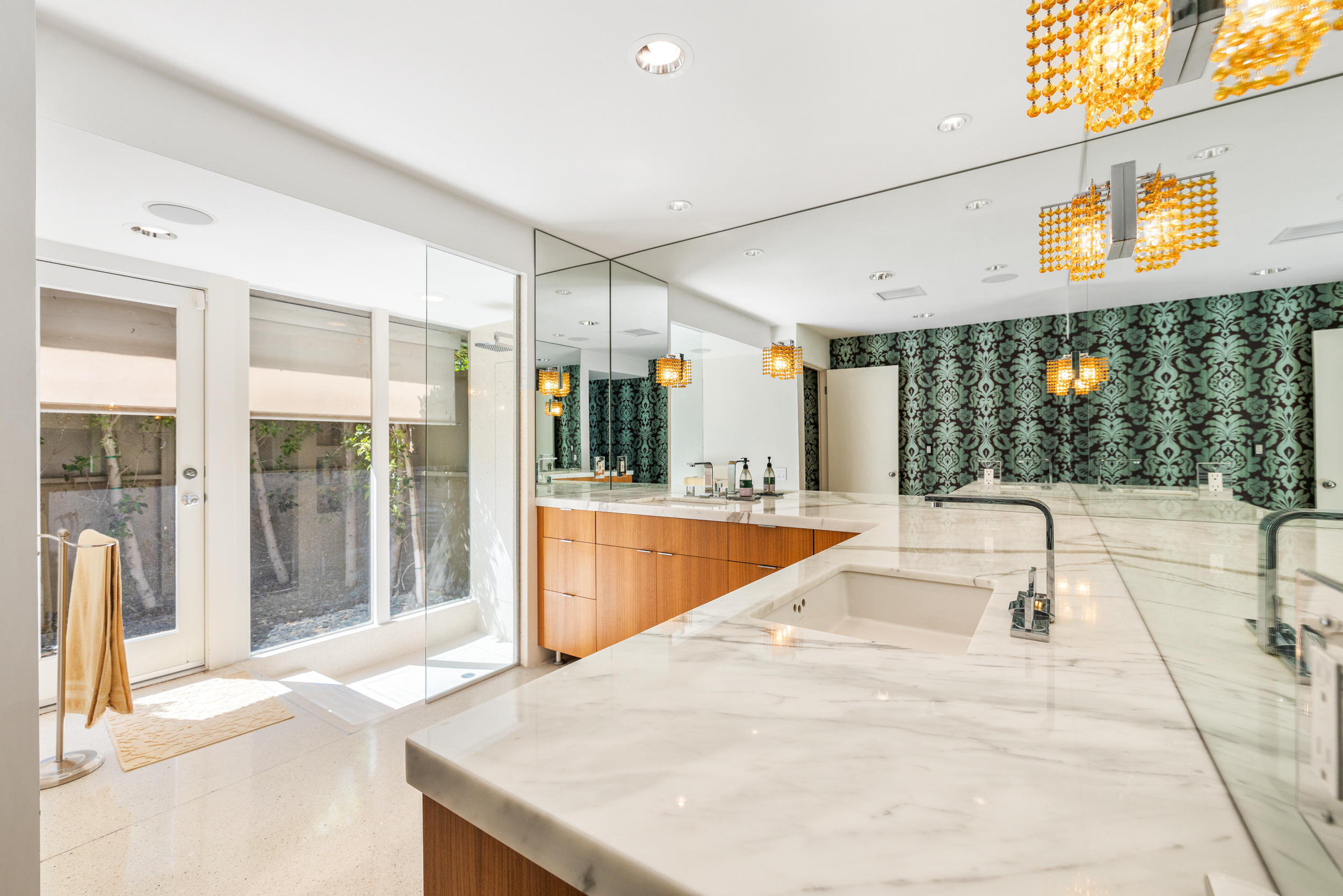 70411 Pecos Road Rancho Mirage, CA 92270 - Photo 20 of 44 a swimming pool with large glass windows and painted walls