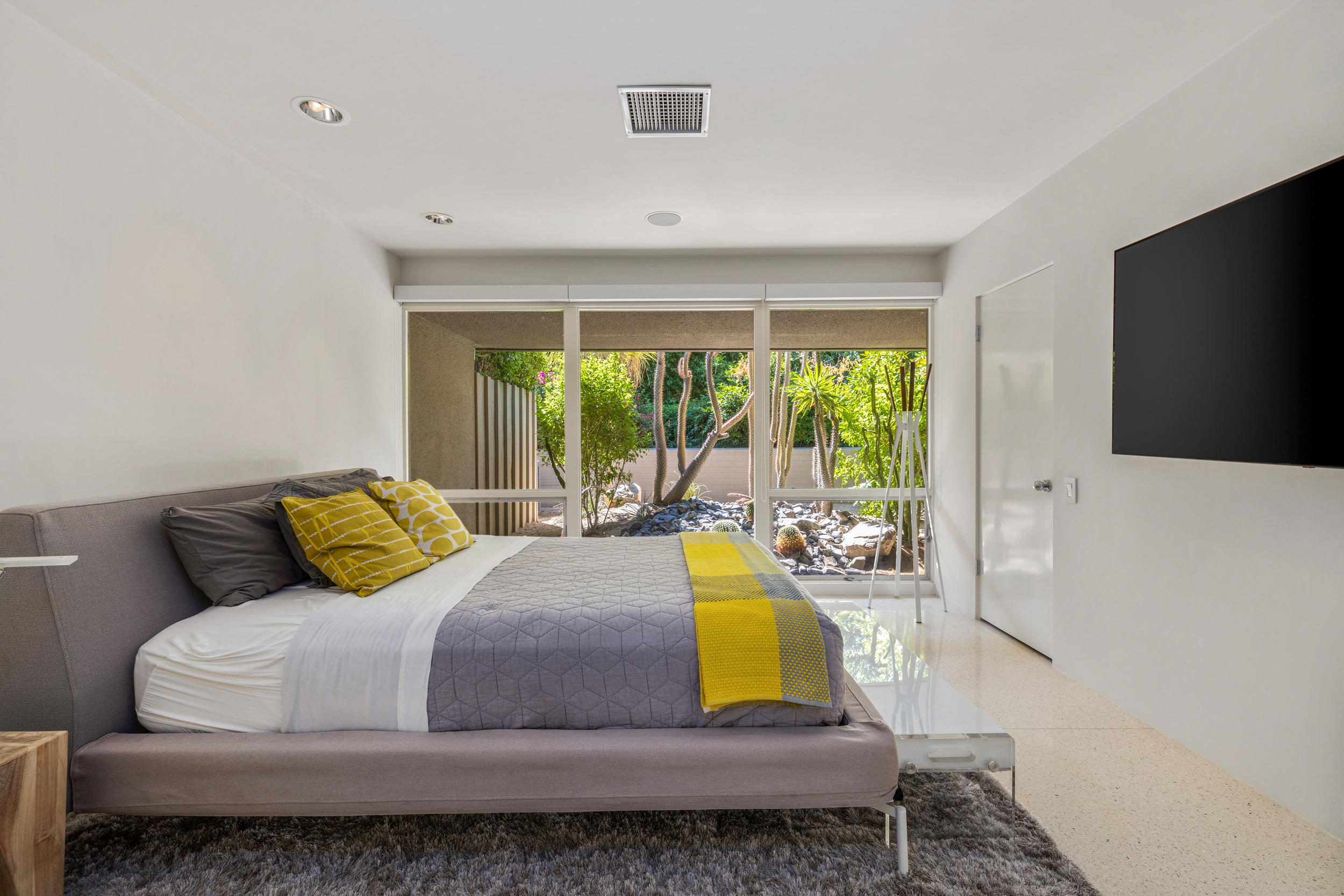 70411 Pecos Road Rancho Mirage, CA 92270 - Photo 30 of 44 a bedroom with a bed and large windows