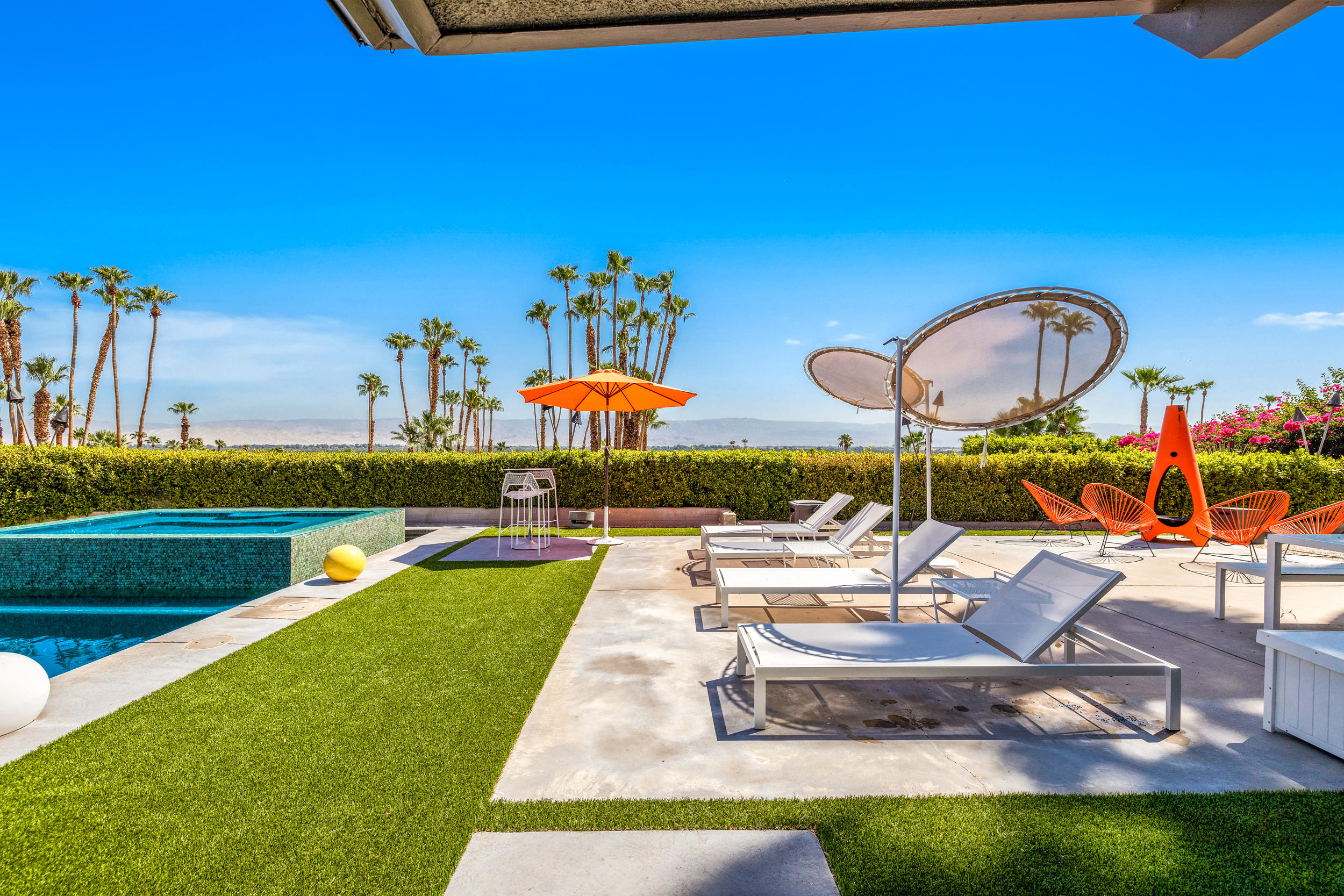 70411 Pecos Road Rancho Mirage, CA 92270 - Photo 38 of 44 a view of a swimming pool with a lounge chairs and a yard