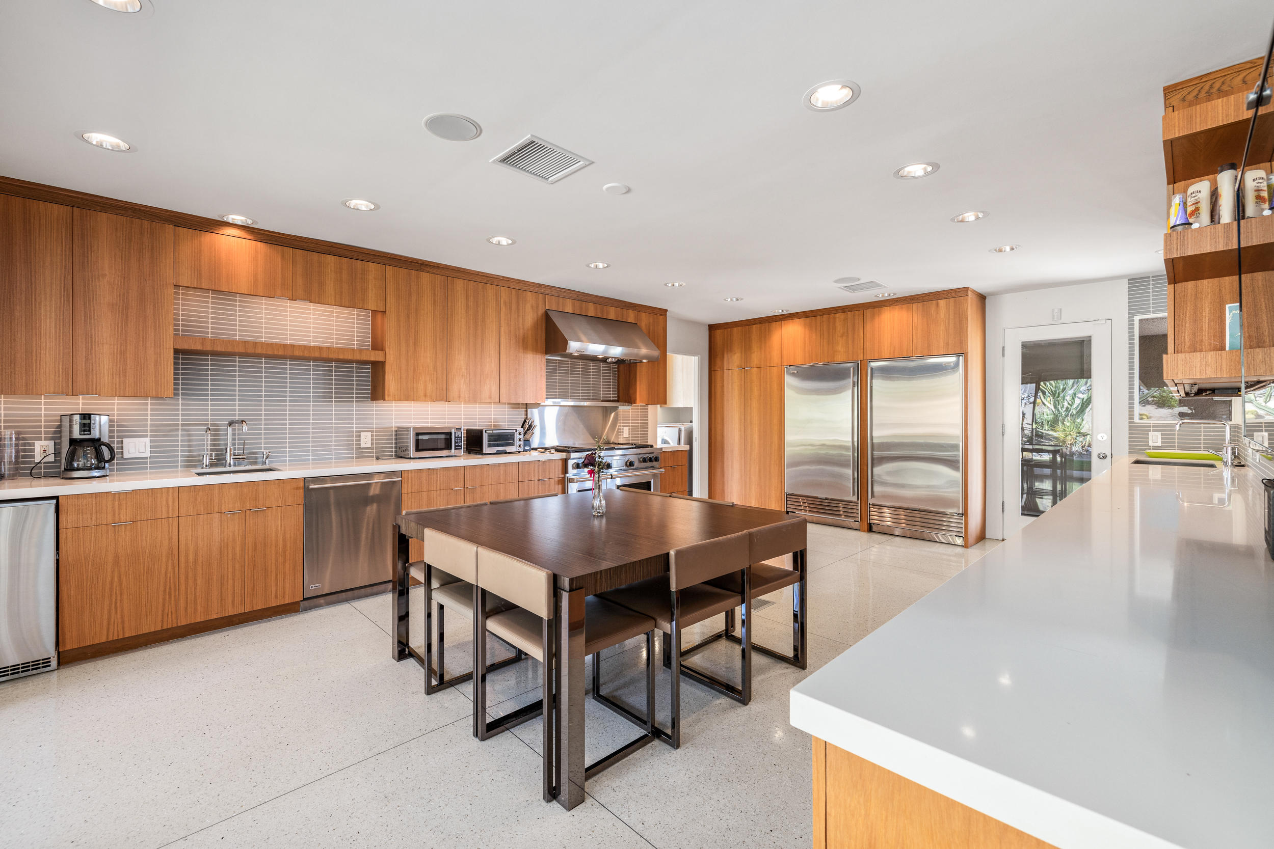 70411 Pecos Road Rancho Mirage, CA 92270 - Photo 10 of 44 a kitchen with a sink a counter top space and stainless steel appliances
