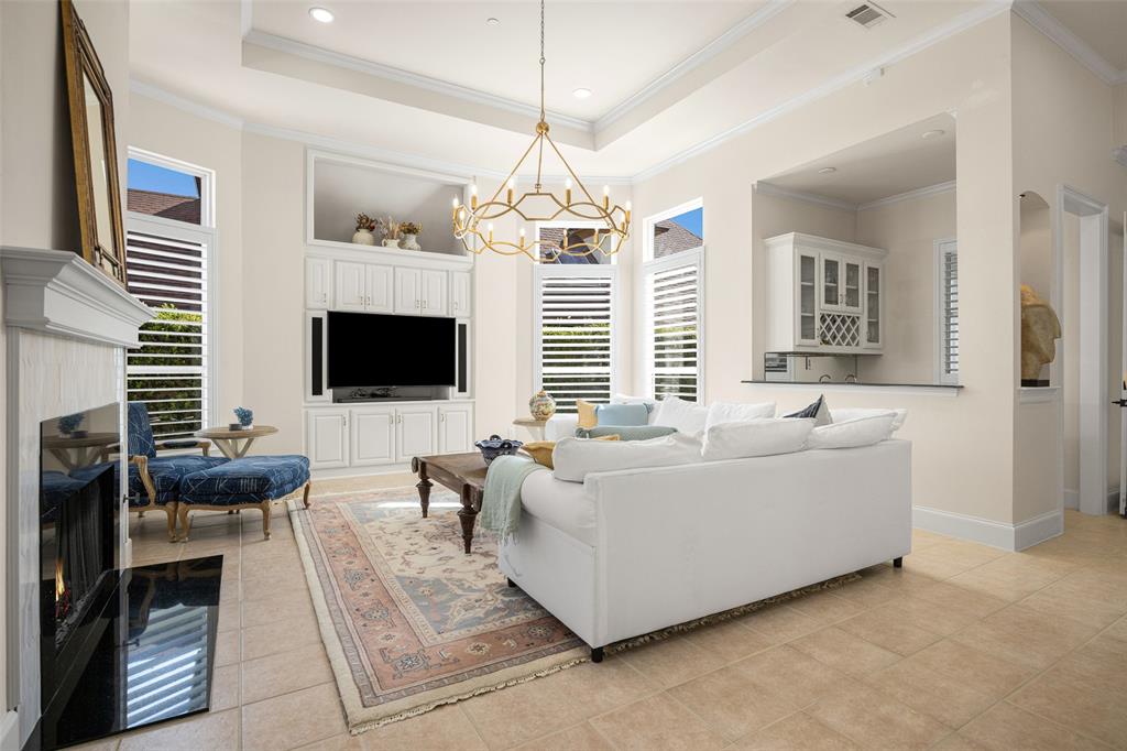 14725 Celestial Place Addison, TX 75254 - Photo 17 of 31 a living room with furniture a flat screen tv and a fireplace