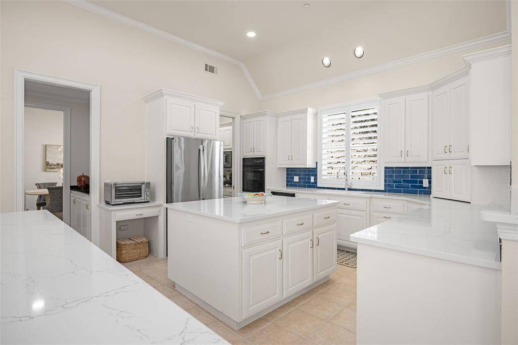 14725 Celestial Place Addison, TX 75254 - Photo 18 of 31 a kitchen with white cabinets and white appliances