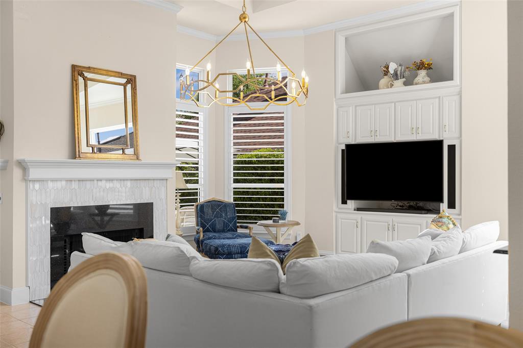 14725 Celestial Place Addison, TX 75254 - Photo 2 of 31 a living room with furniture a fireplace and a flat screen tv