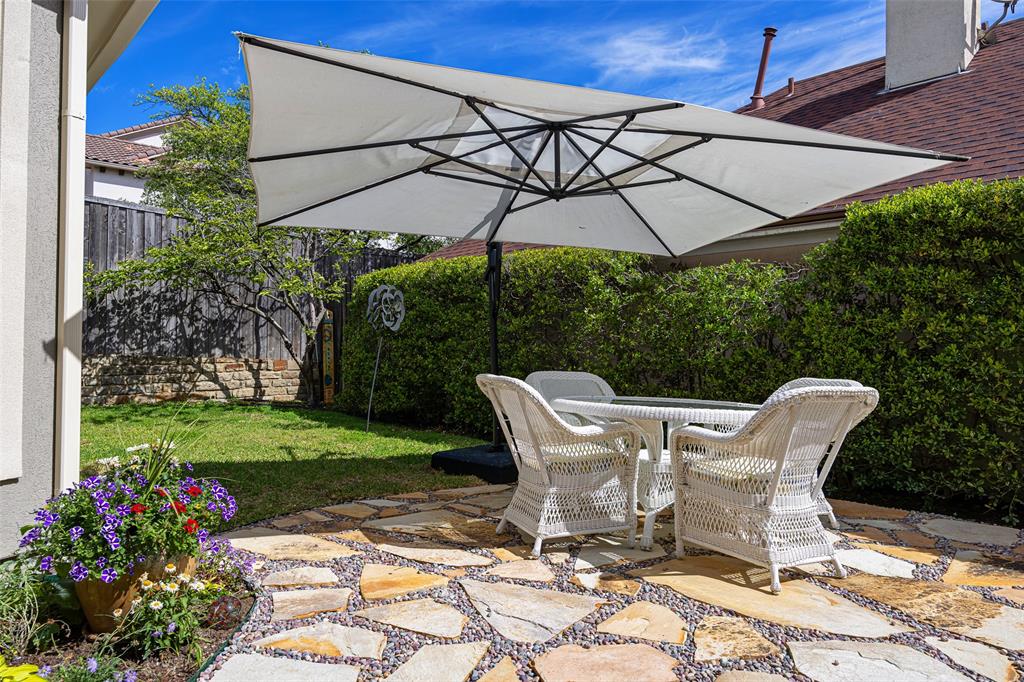 14725 Celestial Place Addison, TX 75254 - Photo 21 of 31 a table and chair under an umbrella