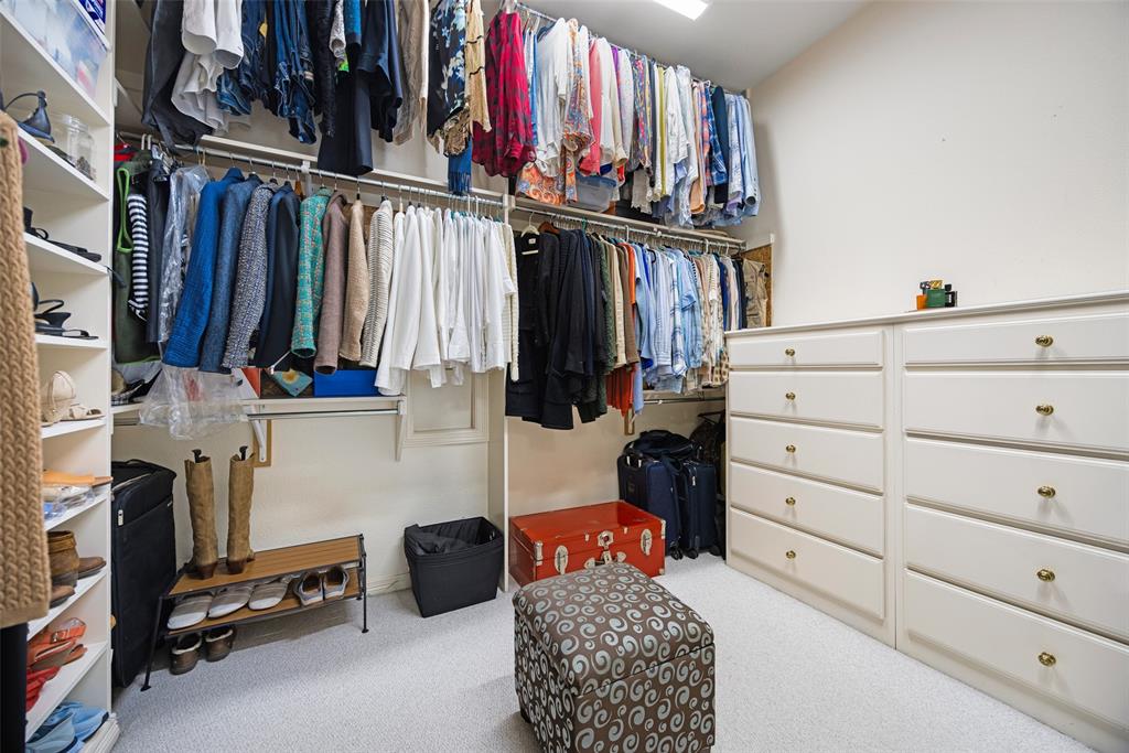 14725 Celestial Place Addison, TX 75254 - Photo 24 of 31 a view of walk in closet with clothes and shoes