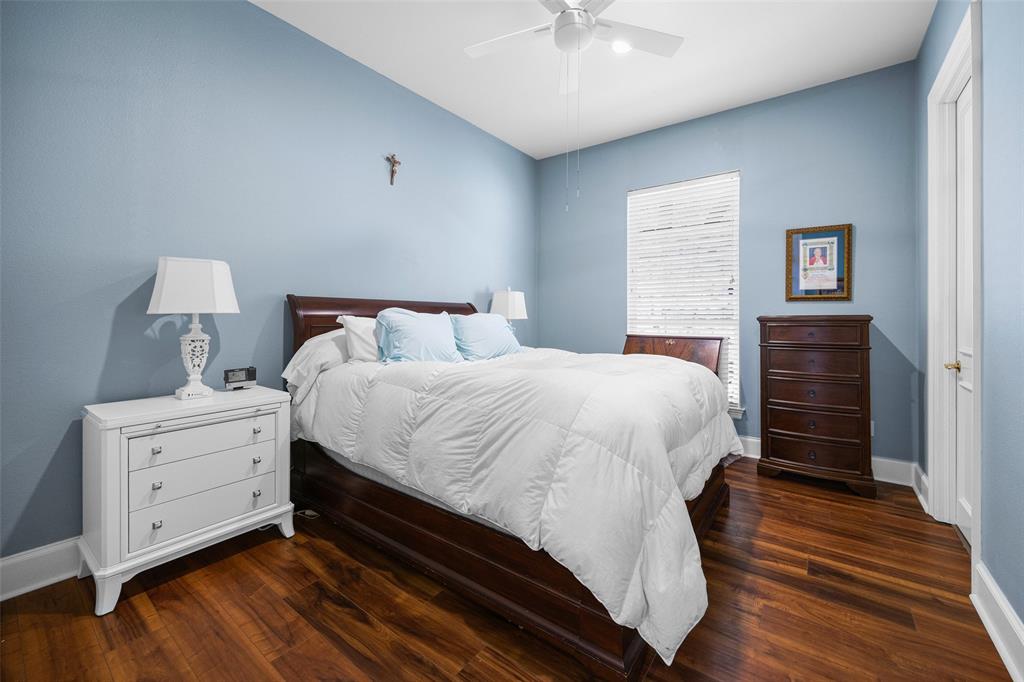14725 Celestial Place Addison, TX 75254 - Photo 25 of 31 a spacious bedroom with a bed and a chandelier