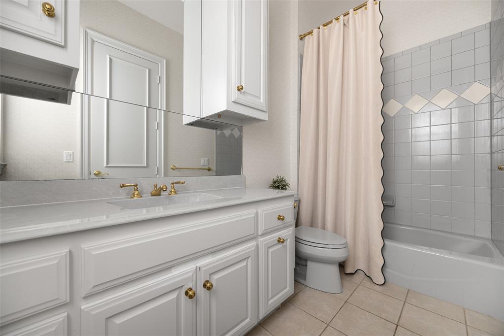 14725 Celestial Place Addison, TX 75254 - Photo 26 of 31 a bathroom with a sink a toilet and shower