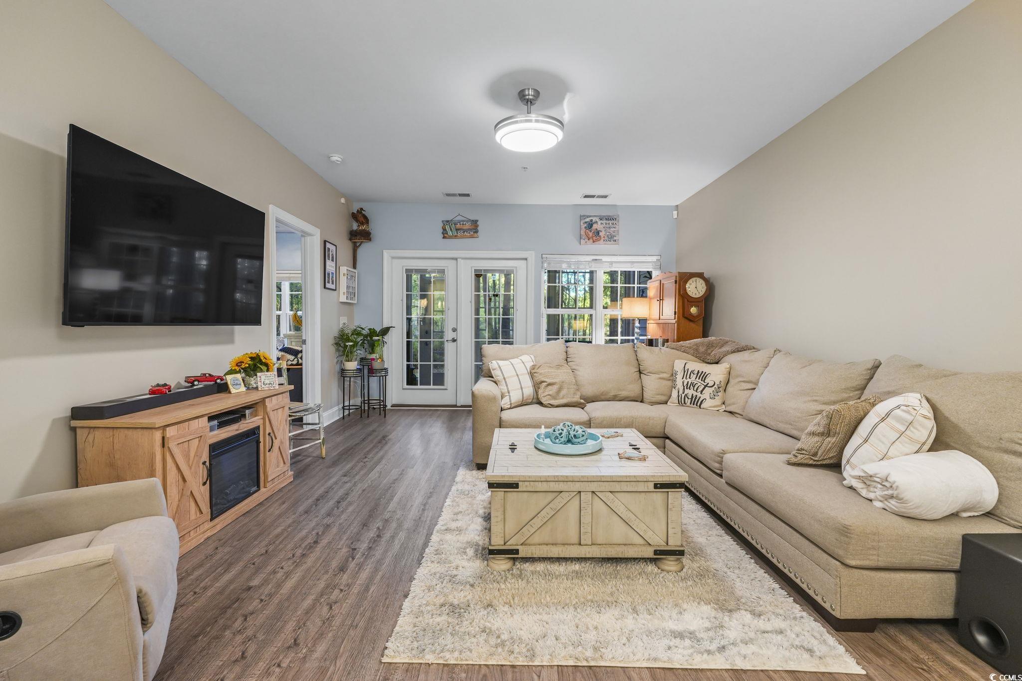 124 Birch N Coppice Drive, Unit 3 Surfside Beach, SC 29575 - Photo 12 of 40 Living room with wood finished floors and french doors