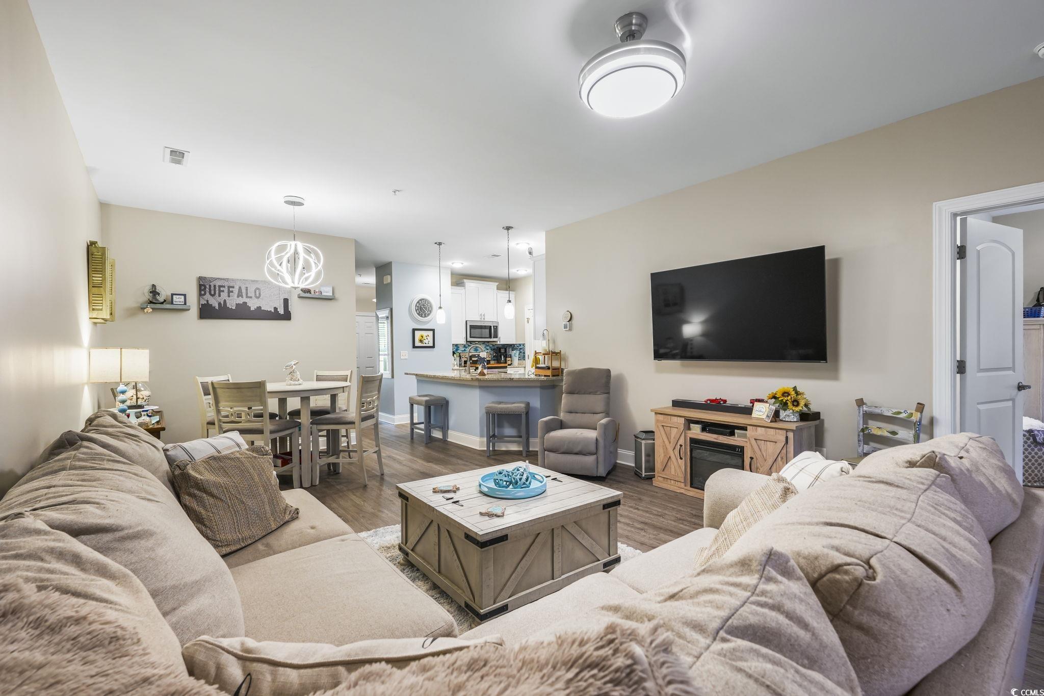 124 Birch N Coppice Drive, Unit 3 Surfside Beach, SC 29575 - Photo 14 of 40 Living area featuring dark wood-style floors
