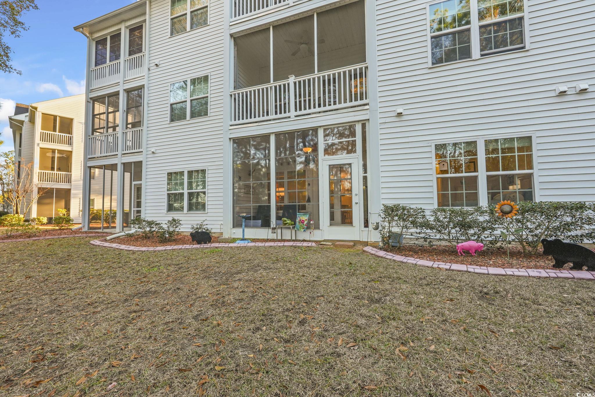 124 Birch N Coppice Drive, Unit 3 Surfside Beach, SC 29575 - Photo 31 of 40 Rear view of the property featuring a yard large enough for a grill